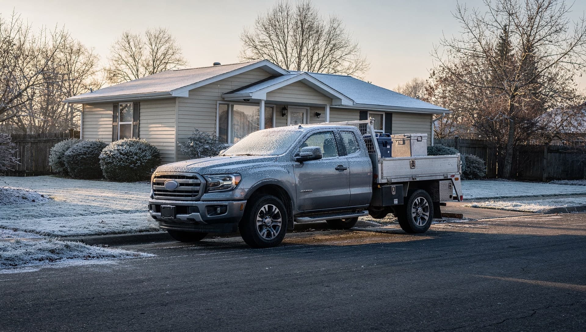 A work truck parked outside a house on a quiet winter morning
