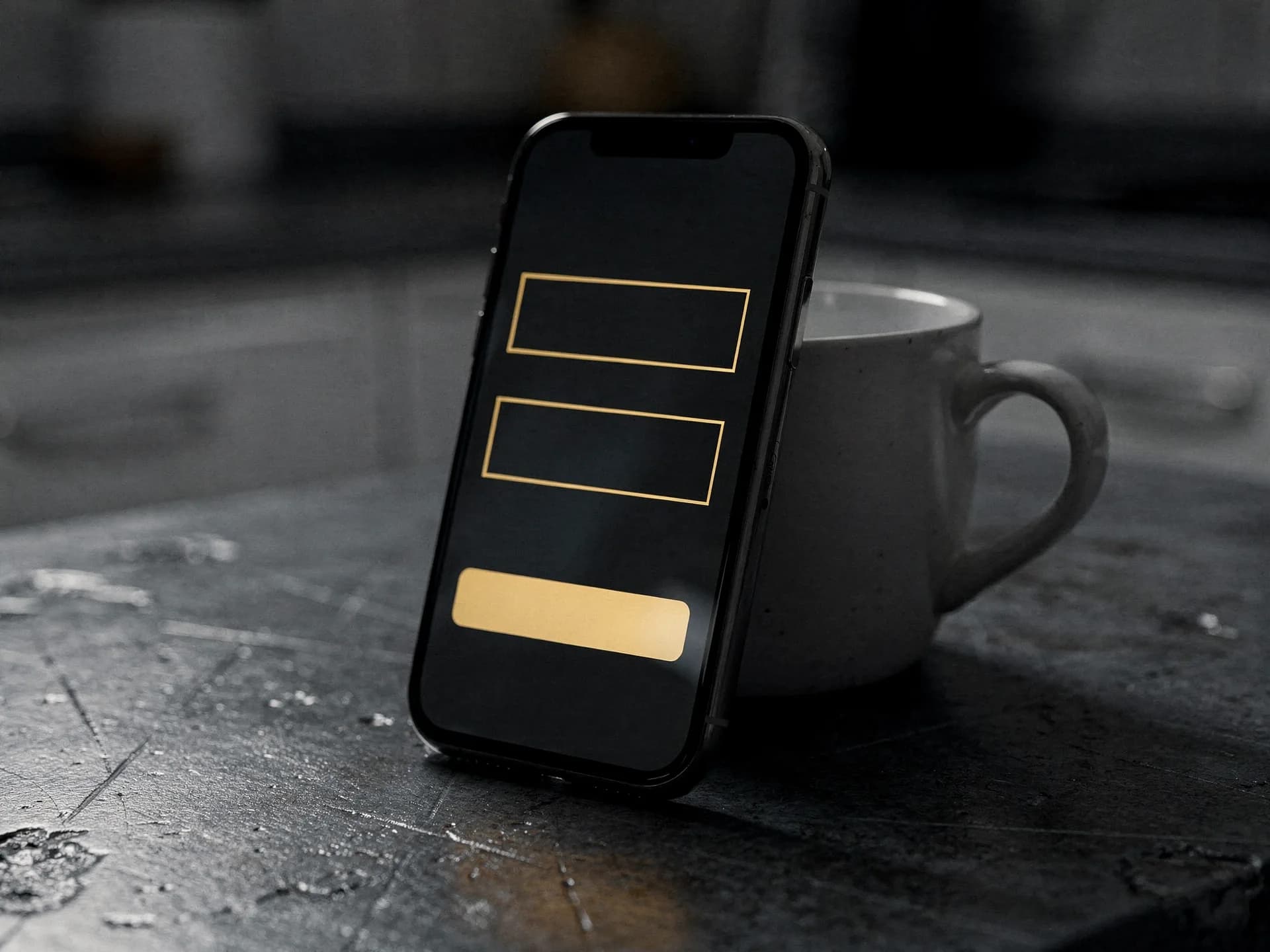 Phone leaning against a white mug on a wet steel counter, its dark screen showing two empty gold-outlined fields and a gold button