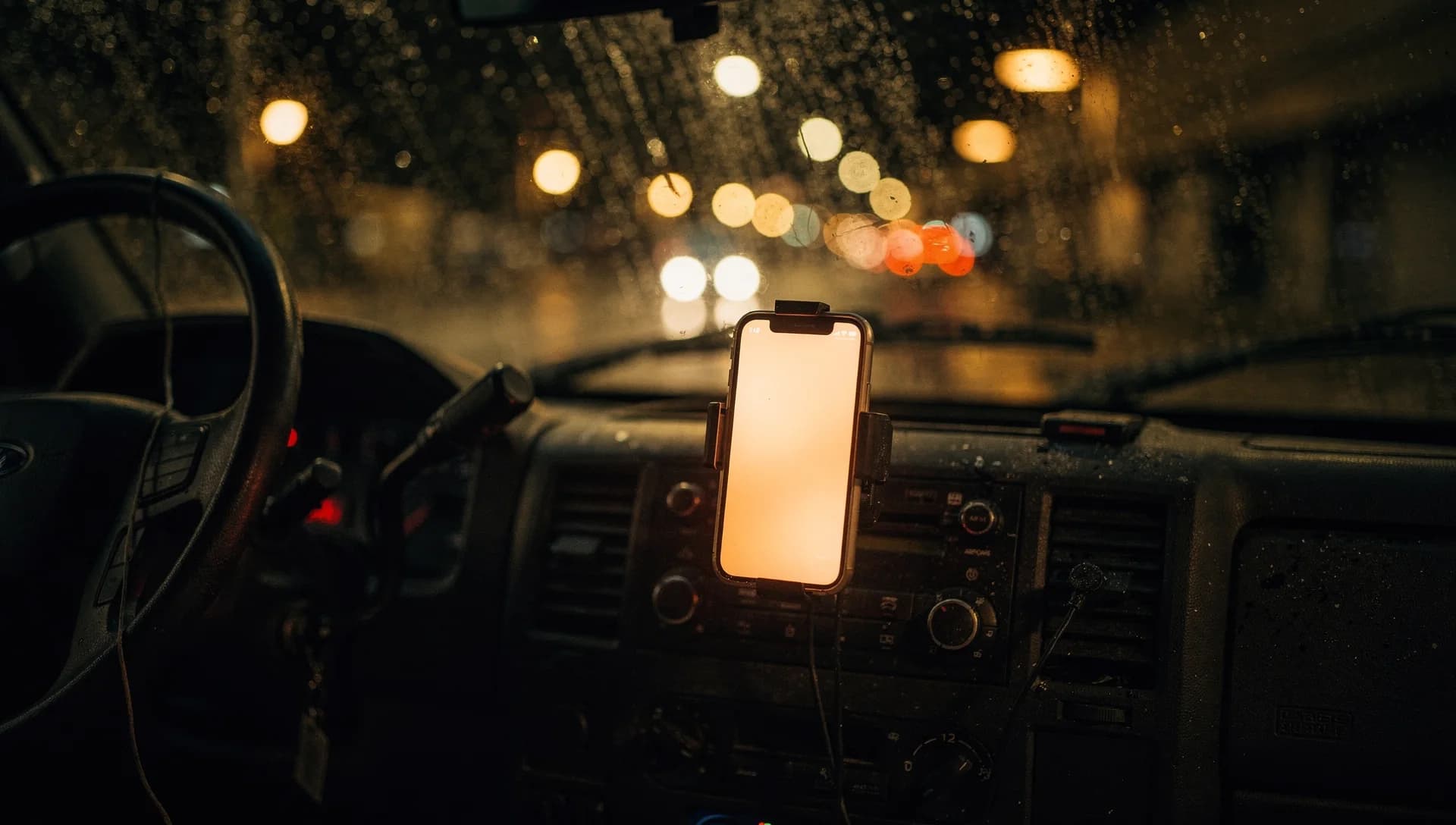 Phone receiving a service call on the console of a work truck at night