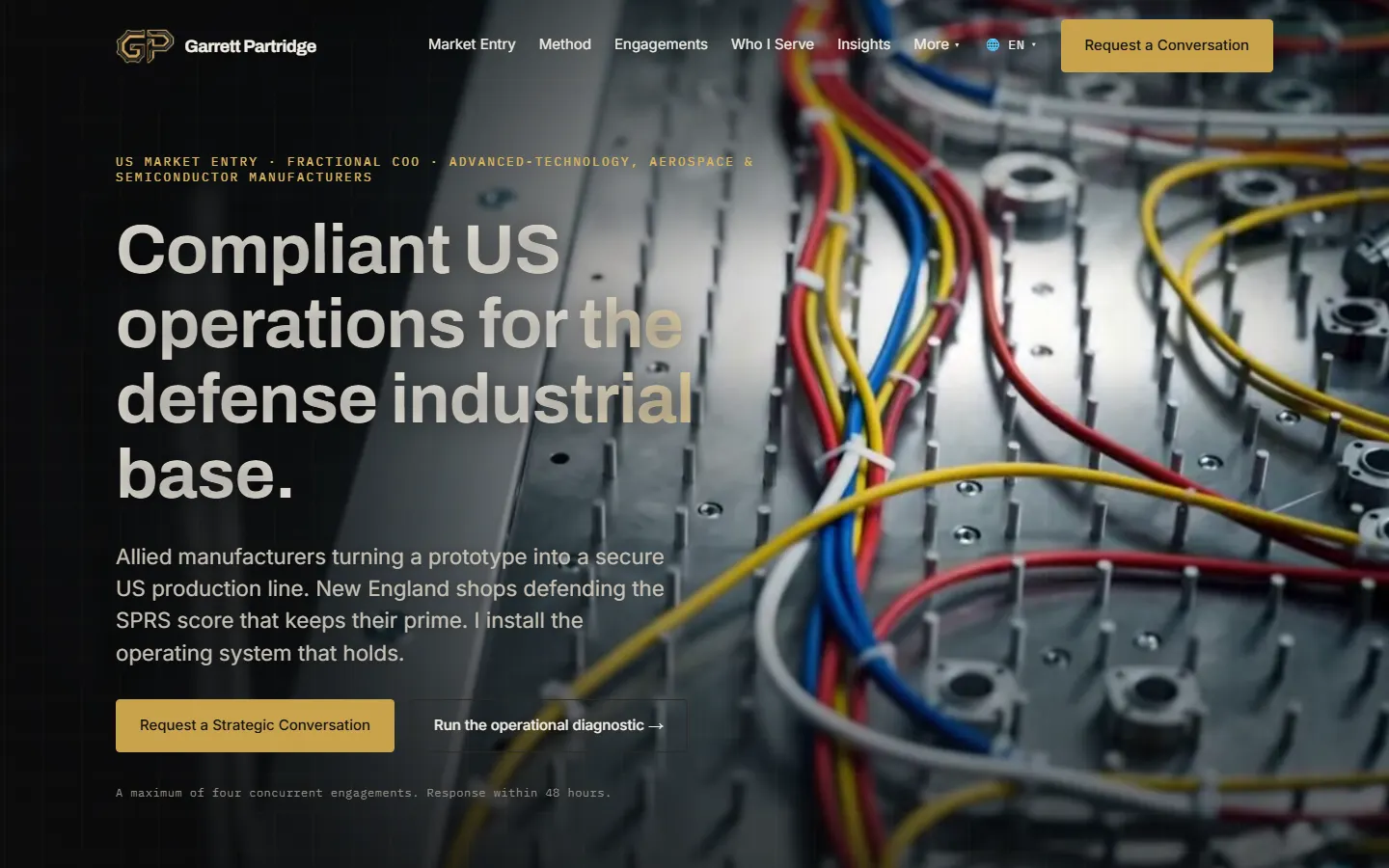 Website hero reading Compliant US operations for the defense industrial base over a close-up of colored wiring in a control cabinet